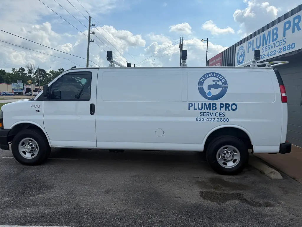 Plumb Pro Services van parked outside the company premises with matching signage